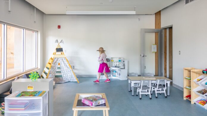 Photo of a child walking through a new classroom.